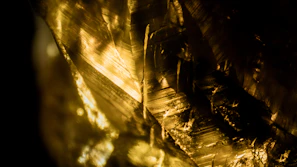 An artistic photo capturing the interplay of light and shadow on satin gold textures.