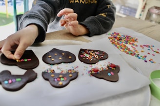 person holding brown and white heart shaped cookies