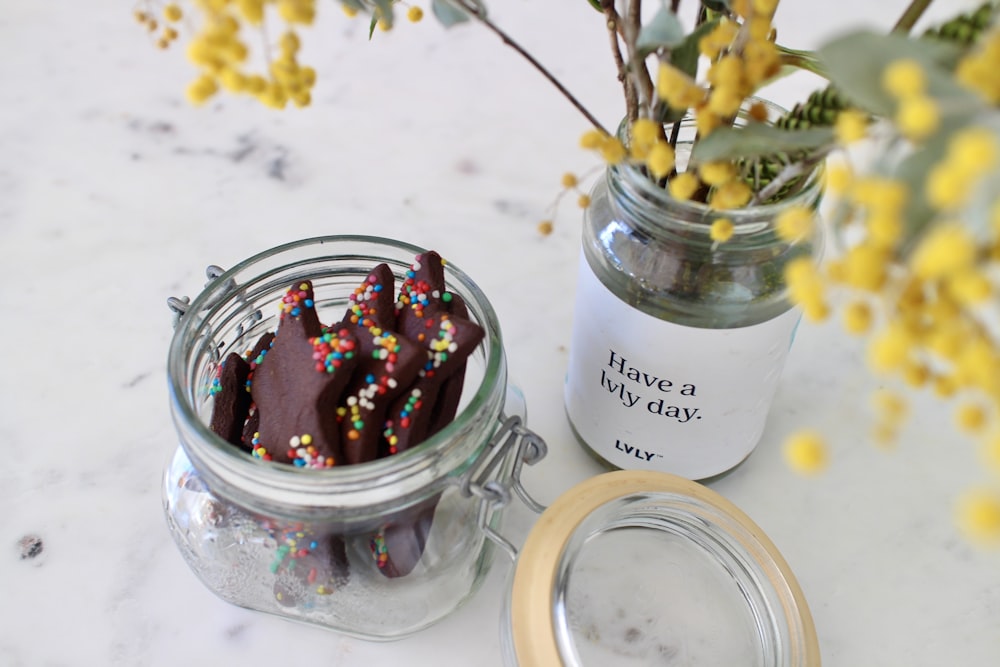 red and yellow flowers in clear glass jar