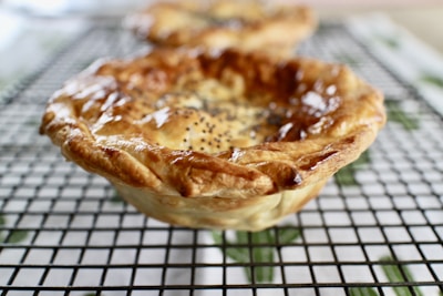 Close-up of a homemade pie cooling on a rustic kitchen counter.