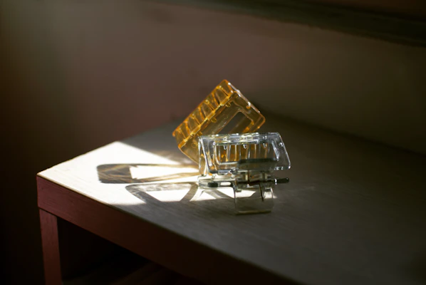 Elegant pearl-studded hair clips sparkling under natural light on a marble surface.
