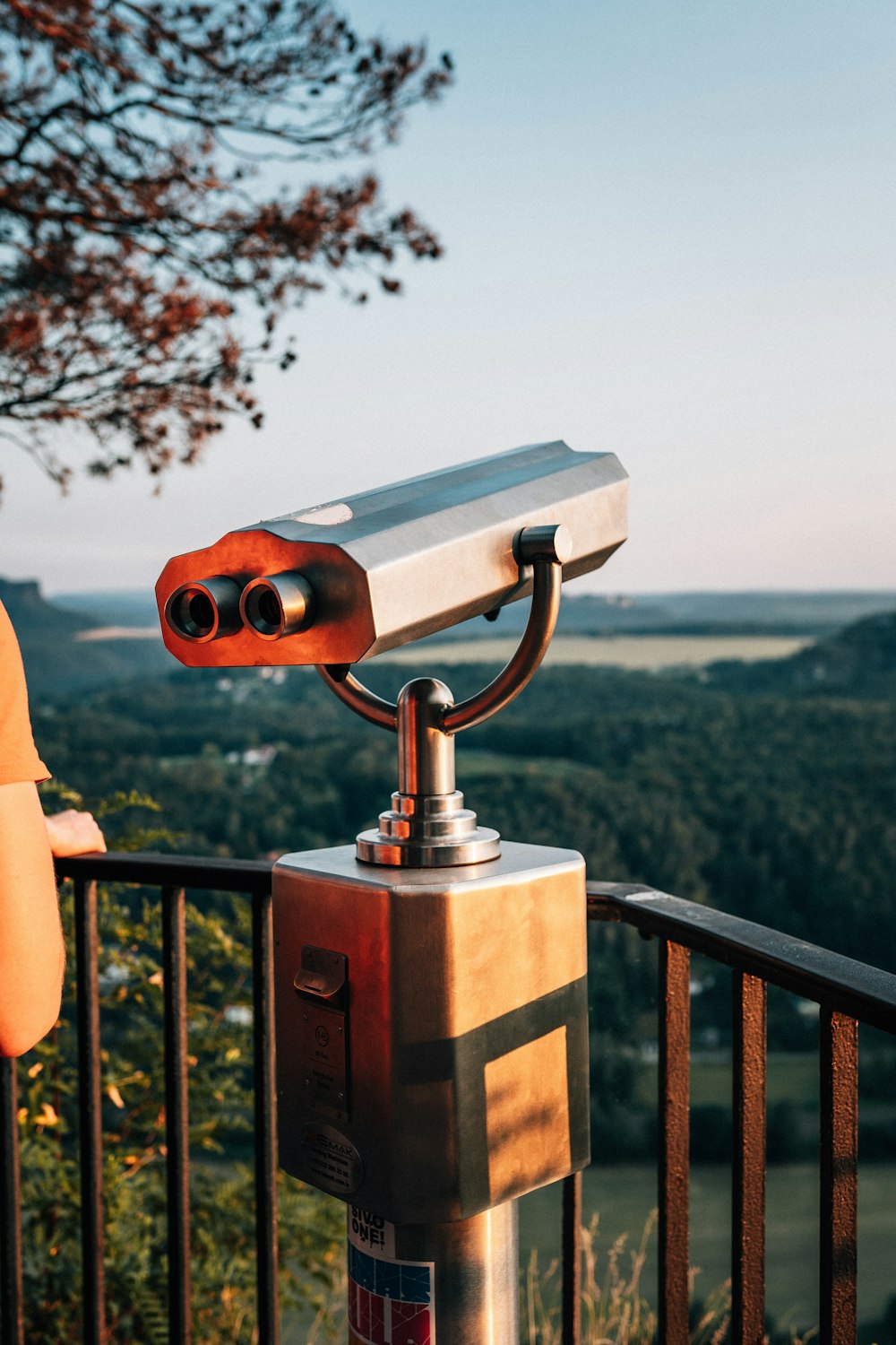 person holding gray and black telescope during daytime