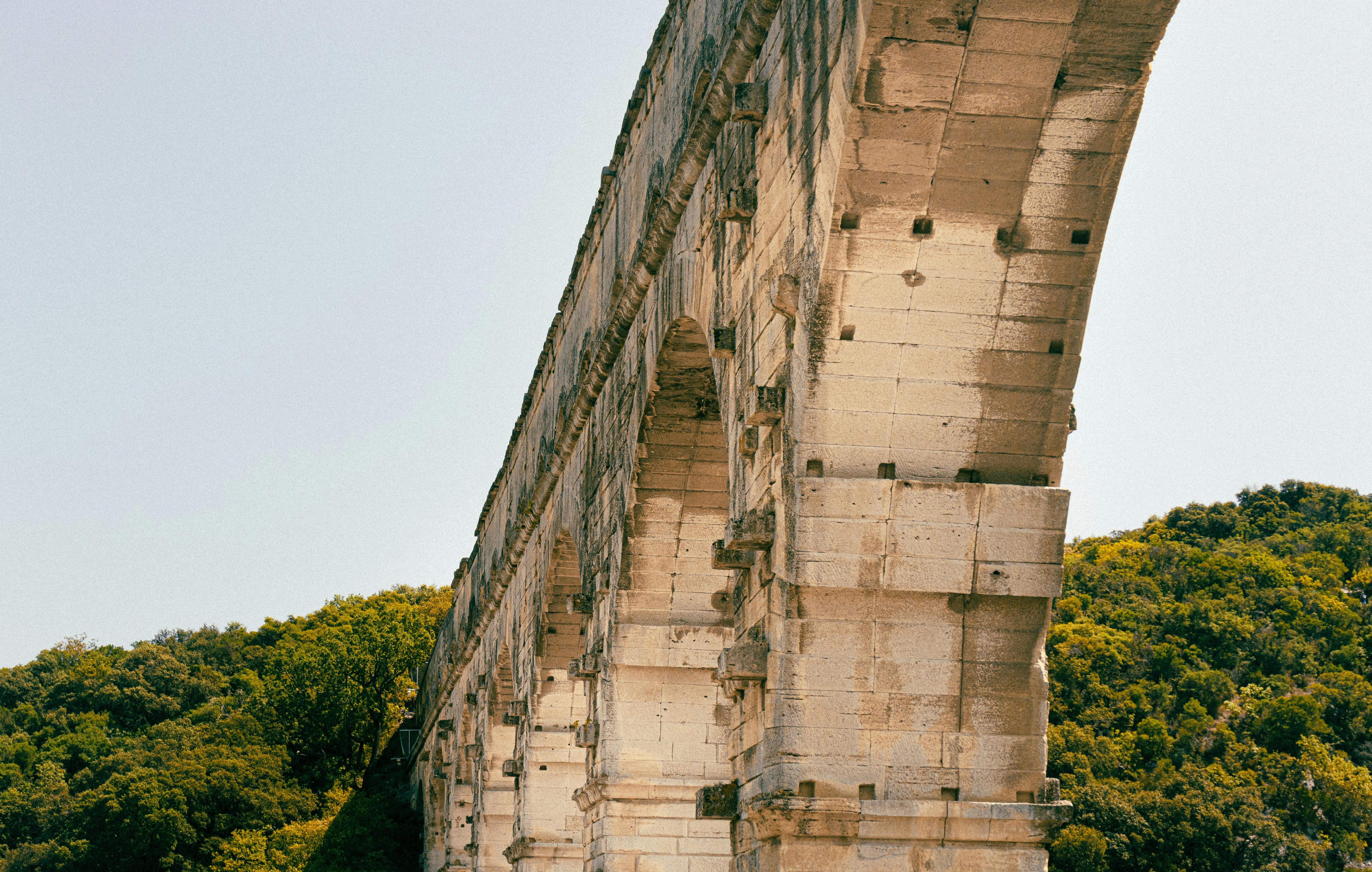 beige concrete building near green trees during daytime