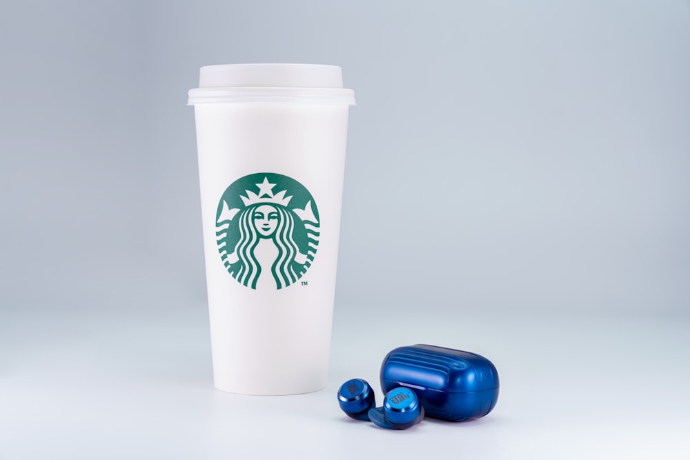 white and green starbucks disposable cup