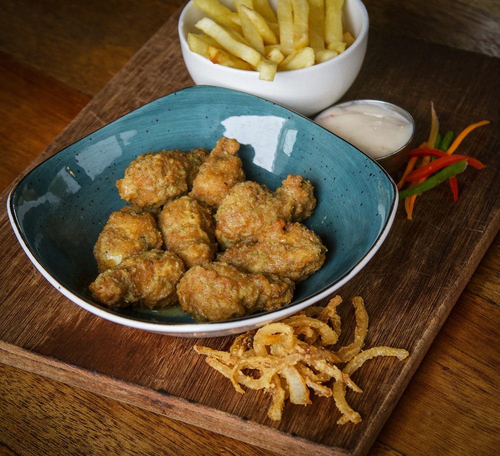 fried chicken on blue ceramic bowl