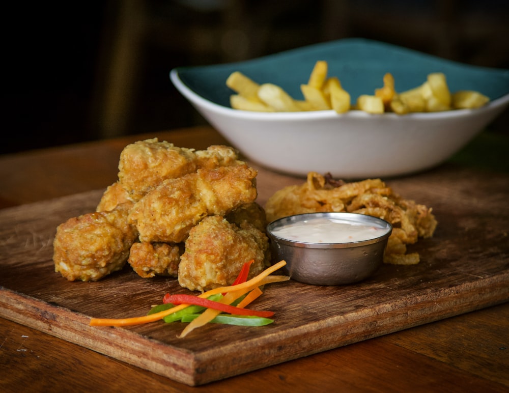 fried food on brown wooden chopping board