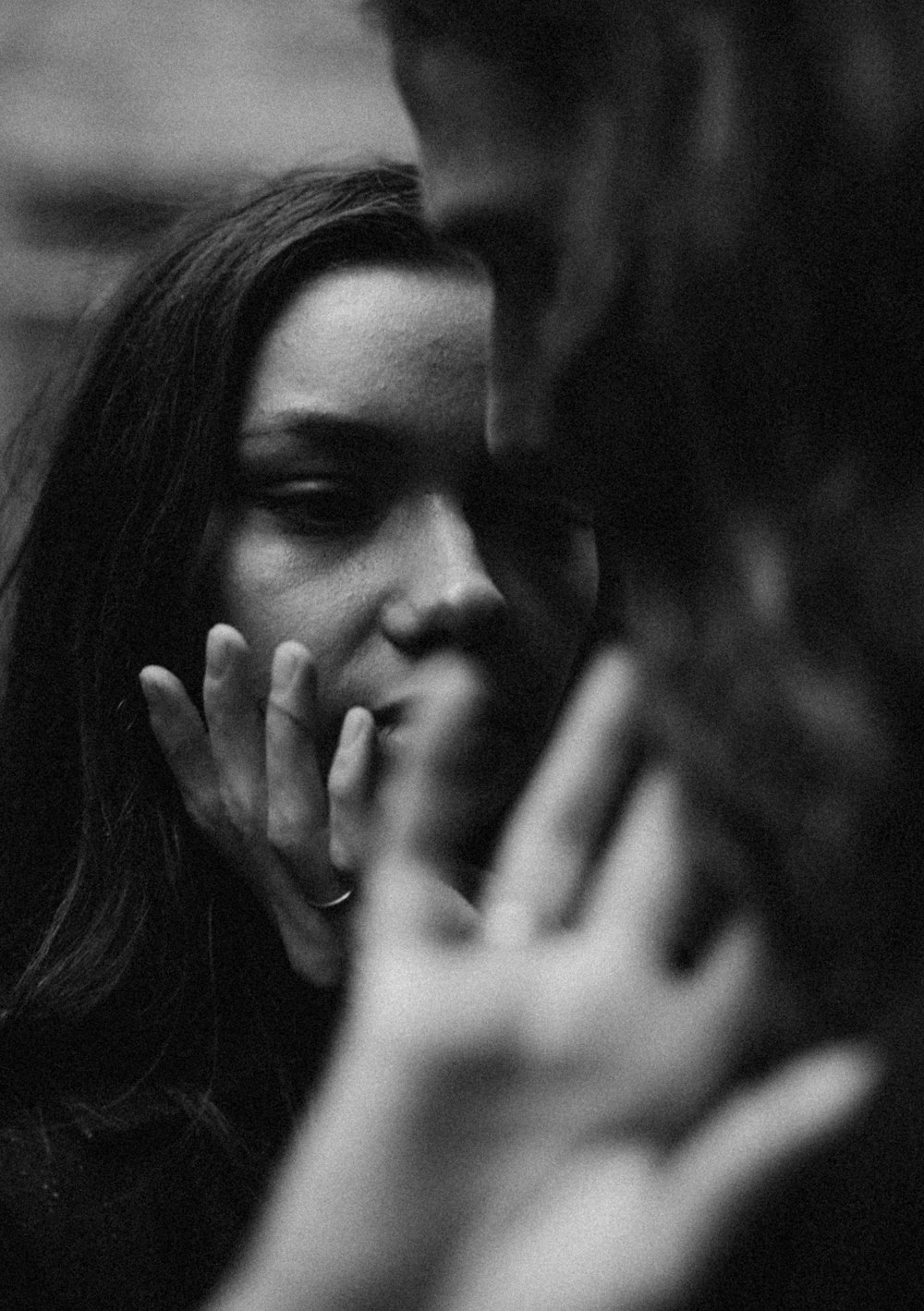 grayscale photo of woman covering her face