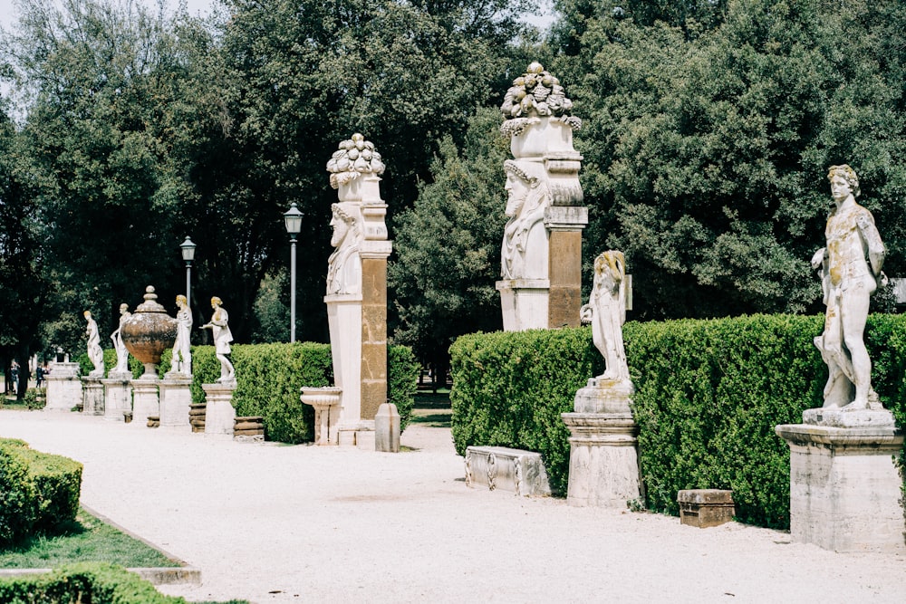 brown concrete statue near green trees during daytime