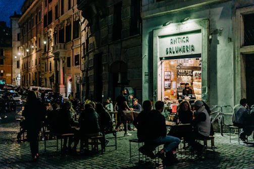 A cozy evening event with people sharing stories inside the edicola.
