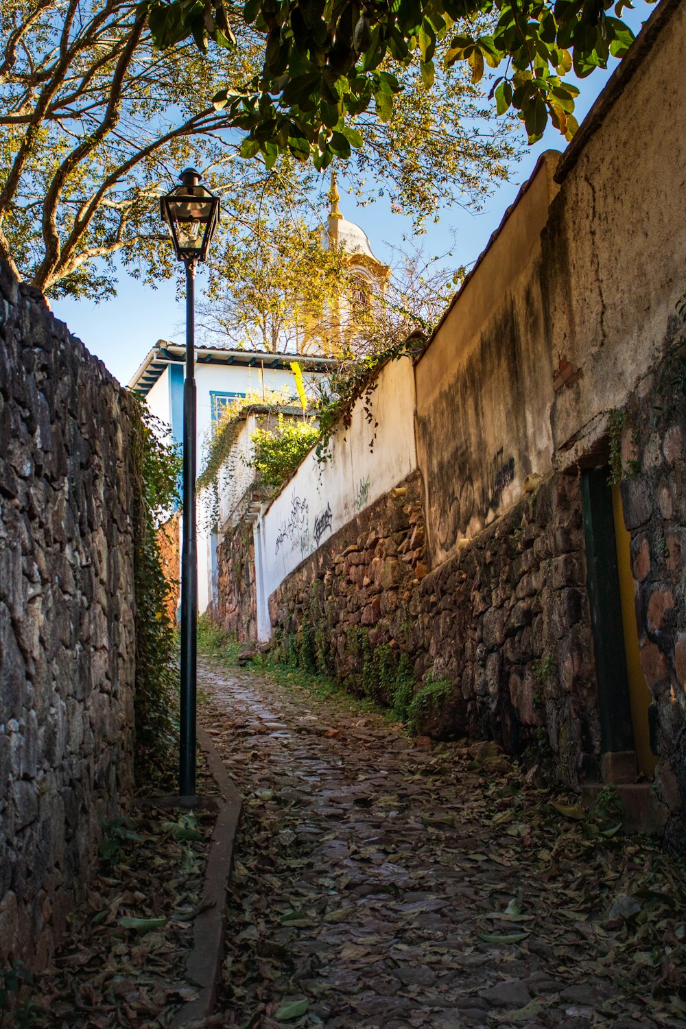 black street light on brown brick wall during daytime