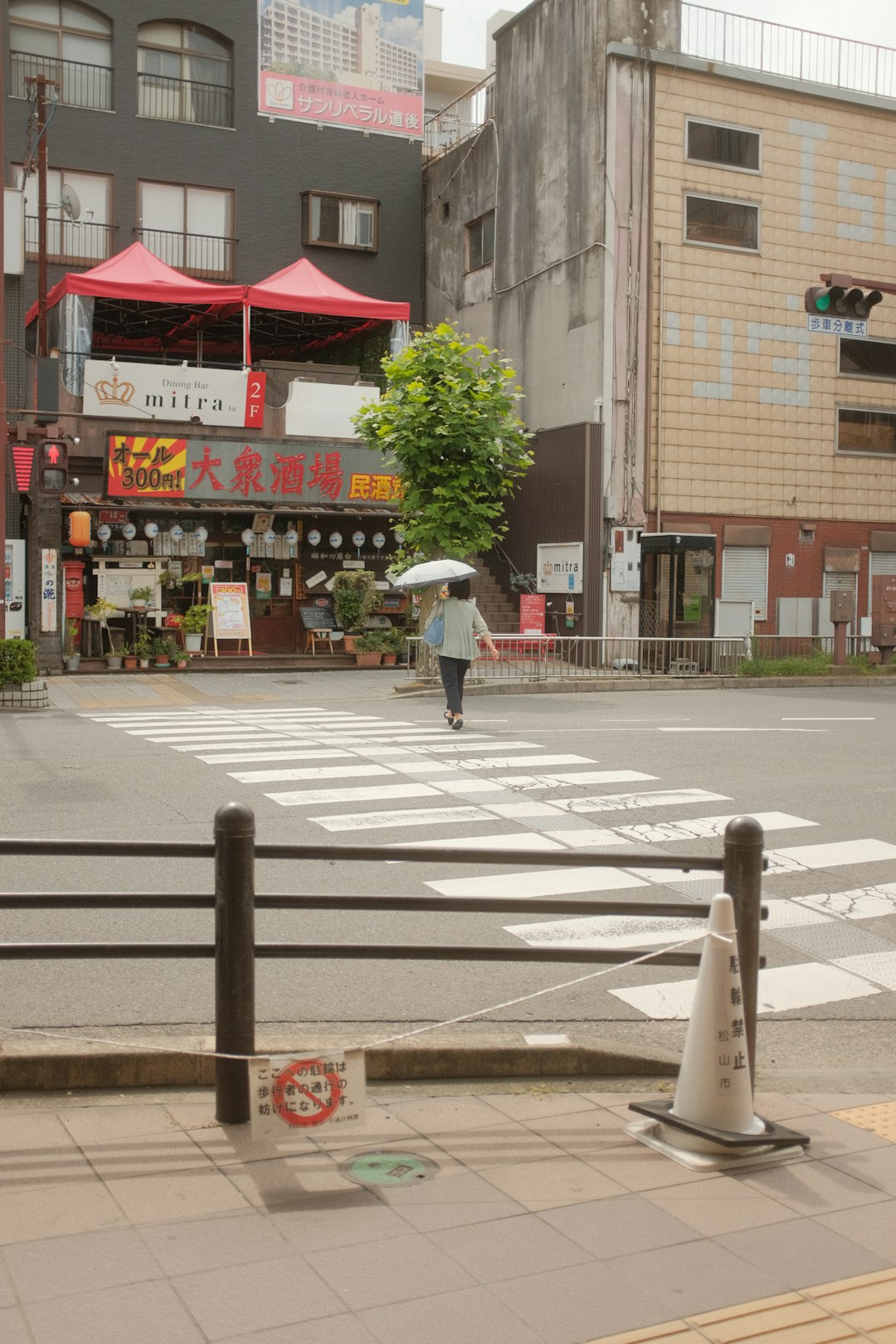 man in white shirt and pants walking on pedestrian lane during daytime