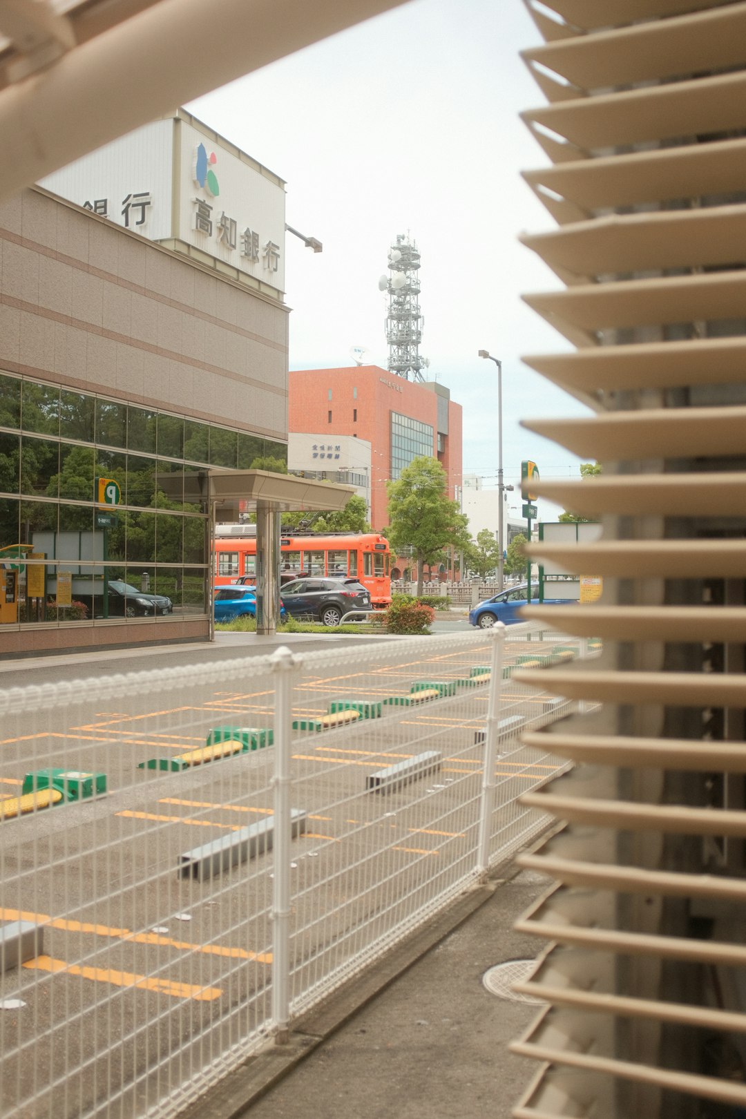 white metal fence near brown concrete building during daytime