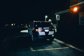 black bmw m 3 parked on parking lot during night time
