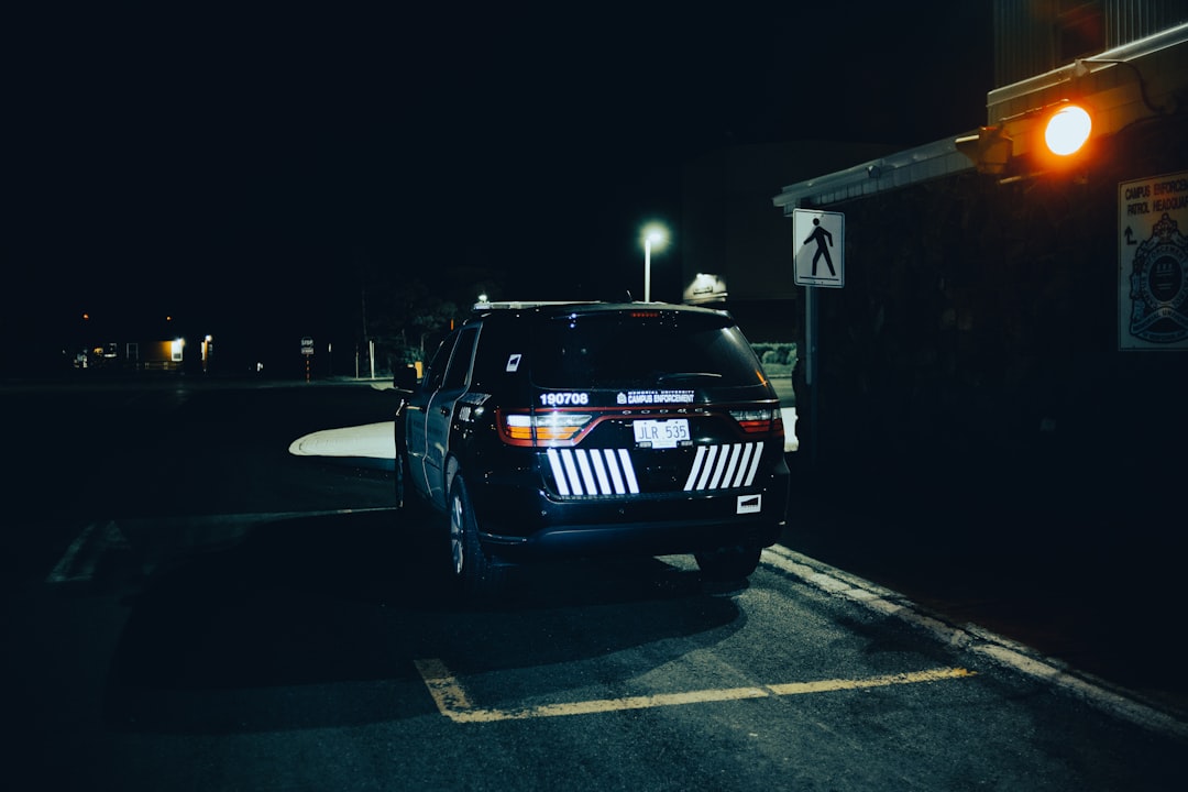 black bmw m 3 parked on parking lot during night time