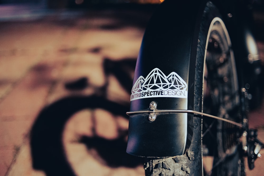 black bicycle tire on brown sand during daytime