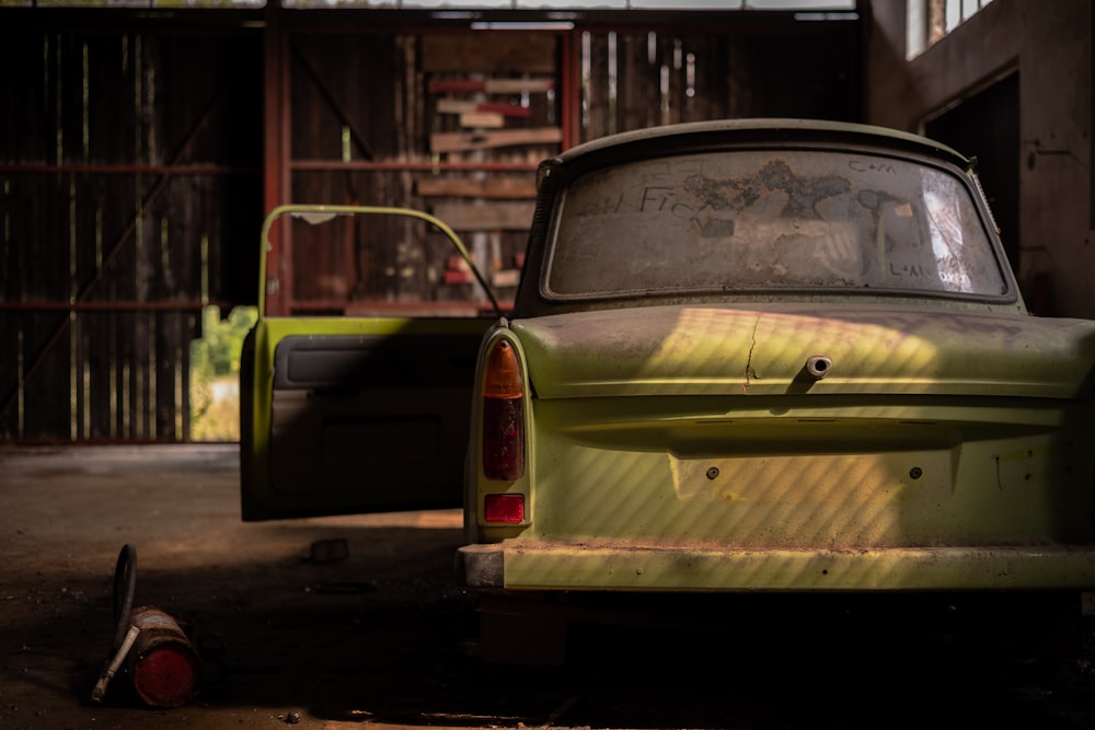 white and green car parked beside building