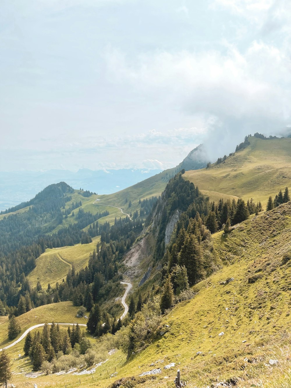 green and brown mountains under white clouds during daytime