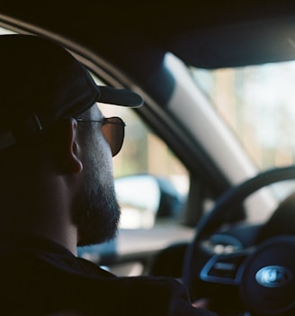 man in black sunglasses driving car during daytime