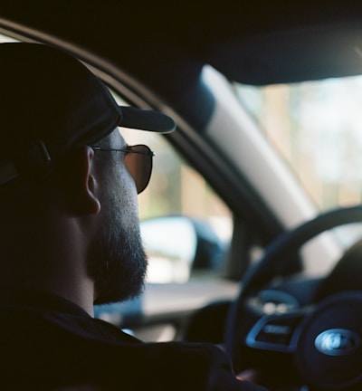 man in black sunglasses driving car during daytime