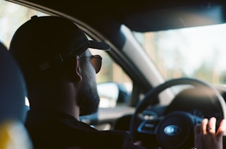 man in black sunglasses driving car during daytime