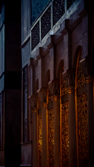 A majestic ancient column bathed in golden light against a deep black background, symbolizing timeless wisdom.