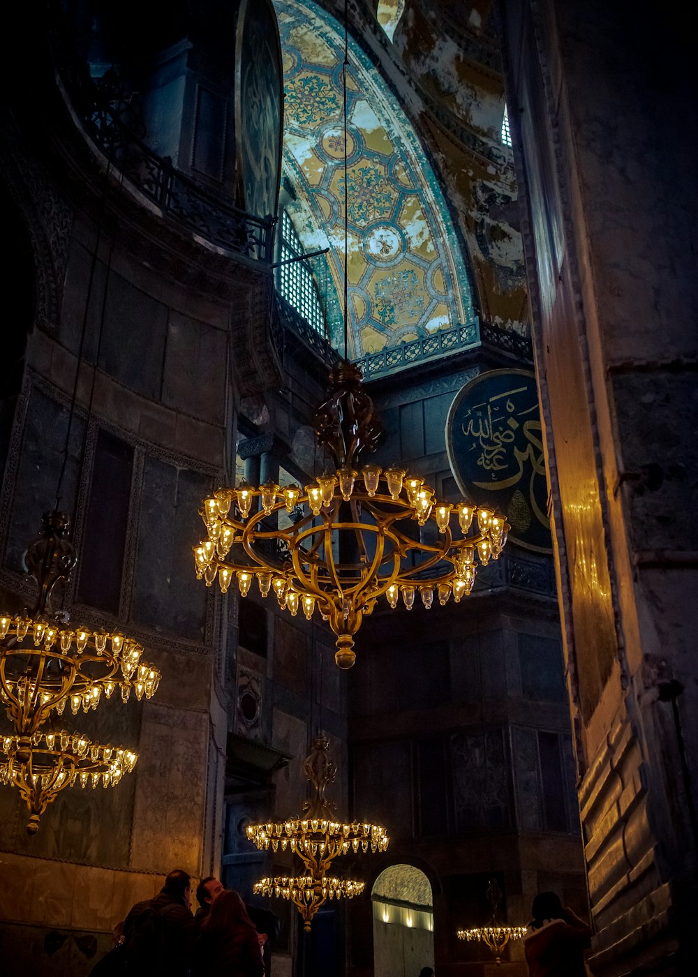 gold chandelier on brown ceiling