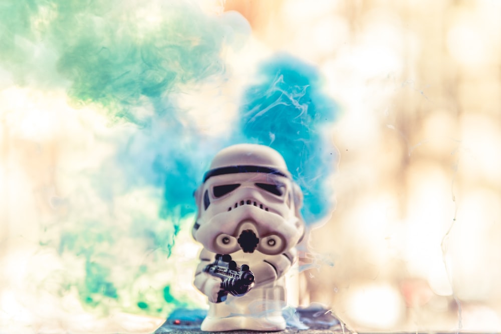 white and blue robot with blue smoke