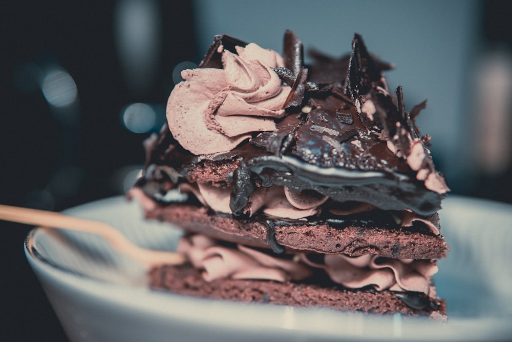 chocolate cake with blue icing on white ceramic plate