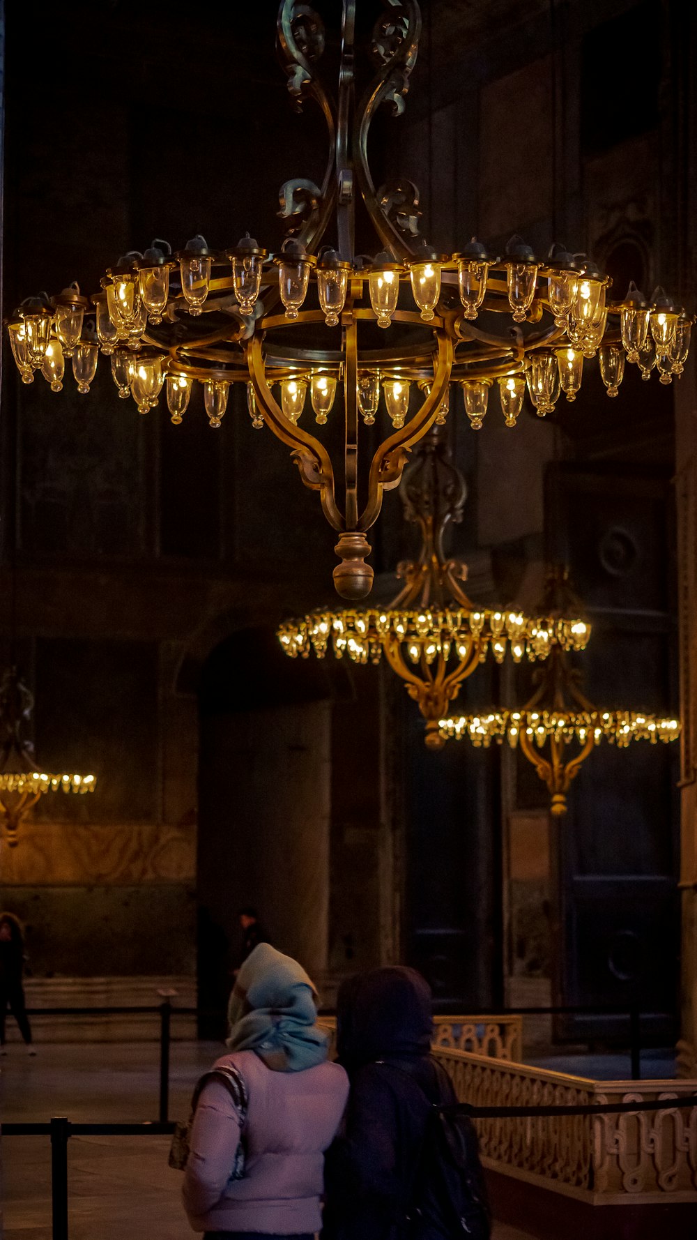 brass uplight chandelier turned on in room