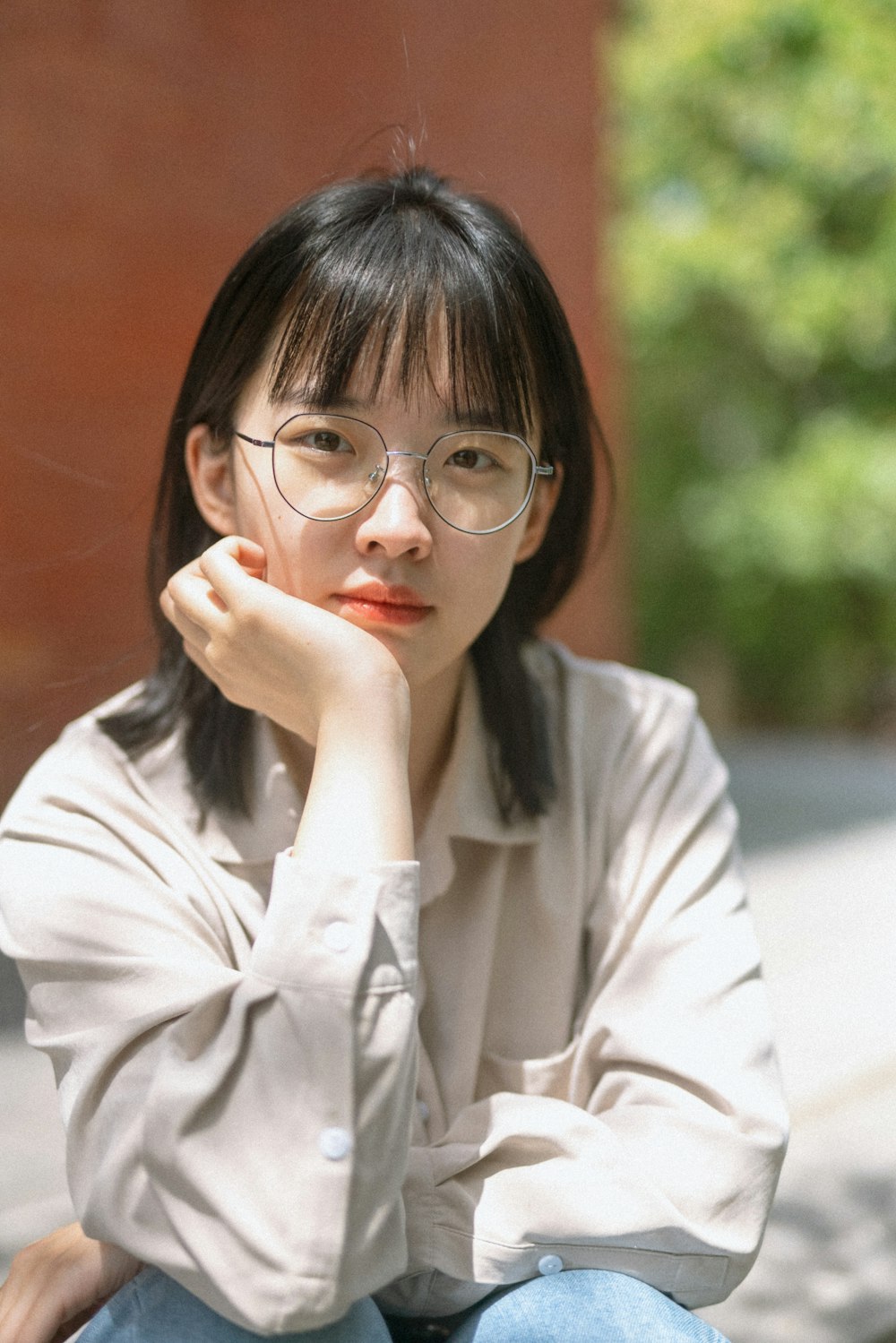 woman in white long sleeve shirt wearing eyeglasses