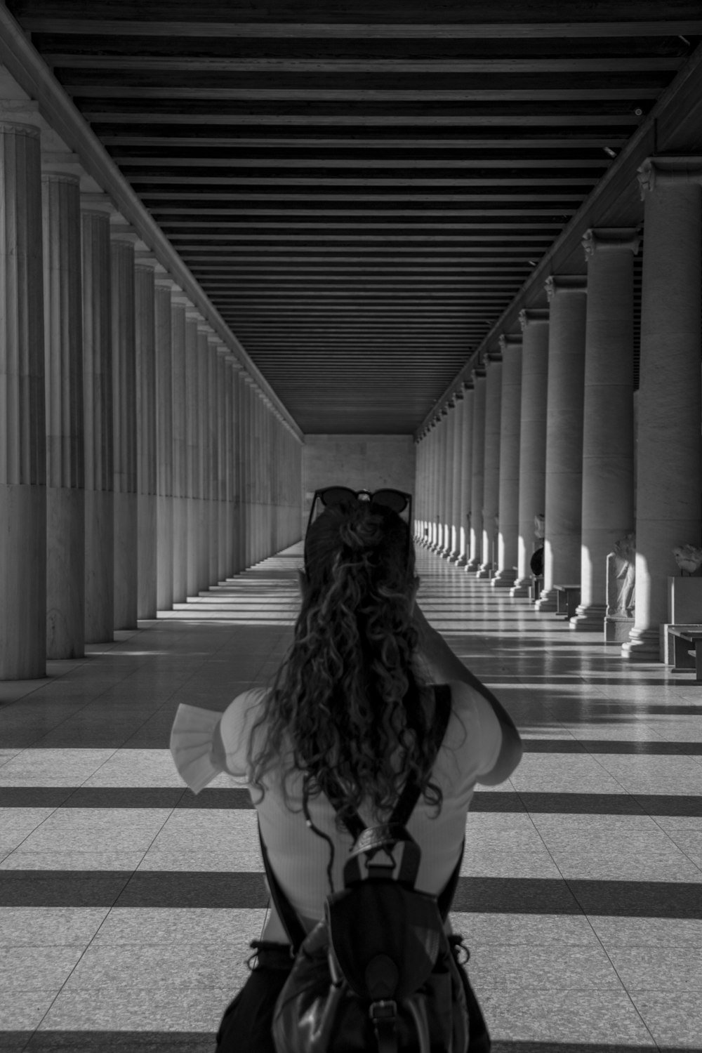 grayscale photo of woman in white dress sitting on floor