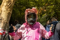 person in pink and white jacket wearing black and yellow helmet