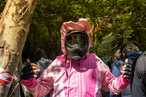 person in pink and white jacket wearing black and yellow helmet