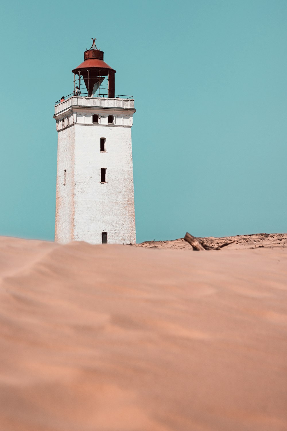 white concrete lighthouse under blue sky during daytime