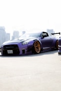 Sleek GTA V tuner car with purple and black graffiti spray paint effects
