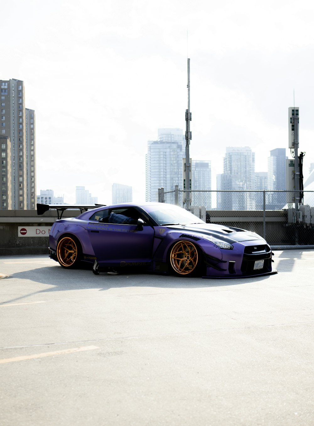purple bmw m 3 coupe on road near city buildings during daytime
