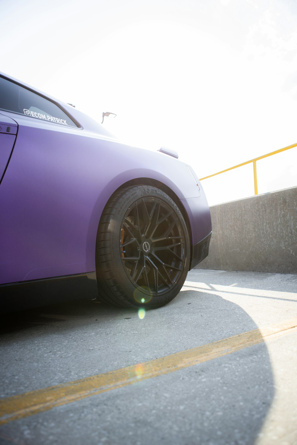 purple car on gray asphalt road