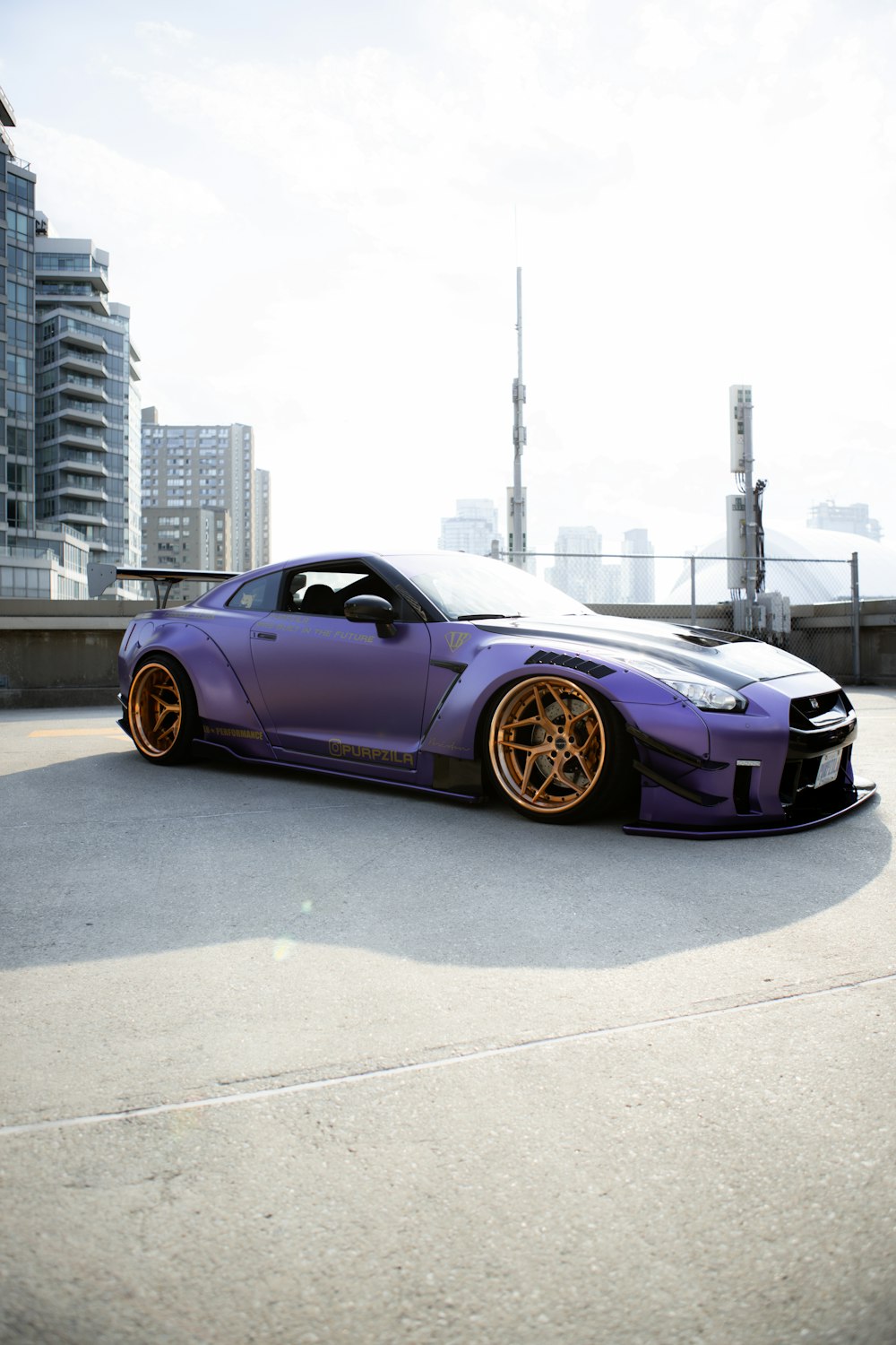 purple porsche 911 parked on gray concrete road during daytime