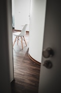 brown wooden chair beside white wall