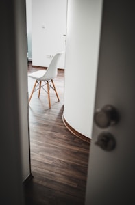 brown wooden chair beside white wall