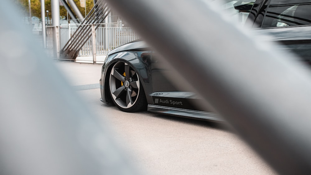 black porsche 911 parked on gray concrete pavement during daytime