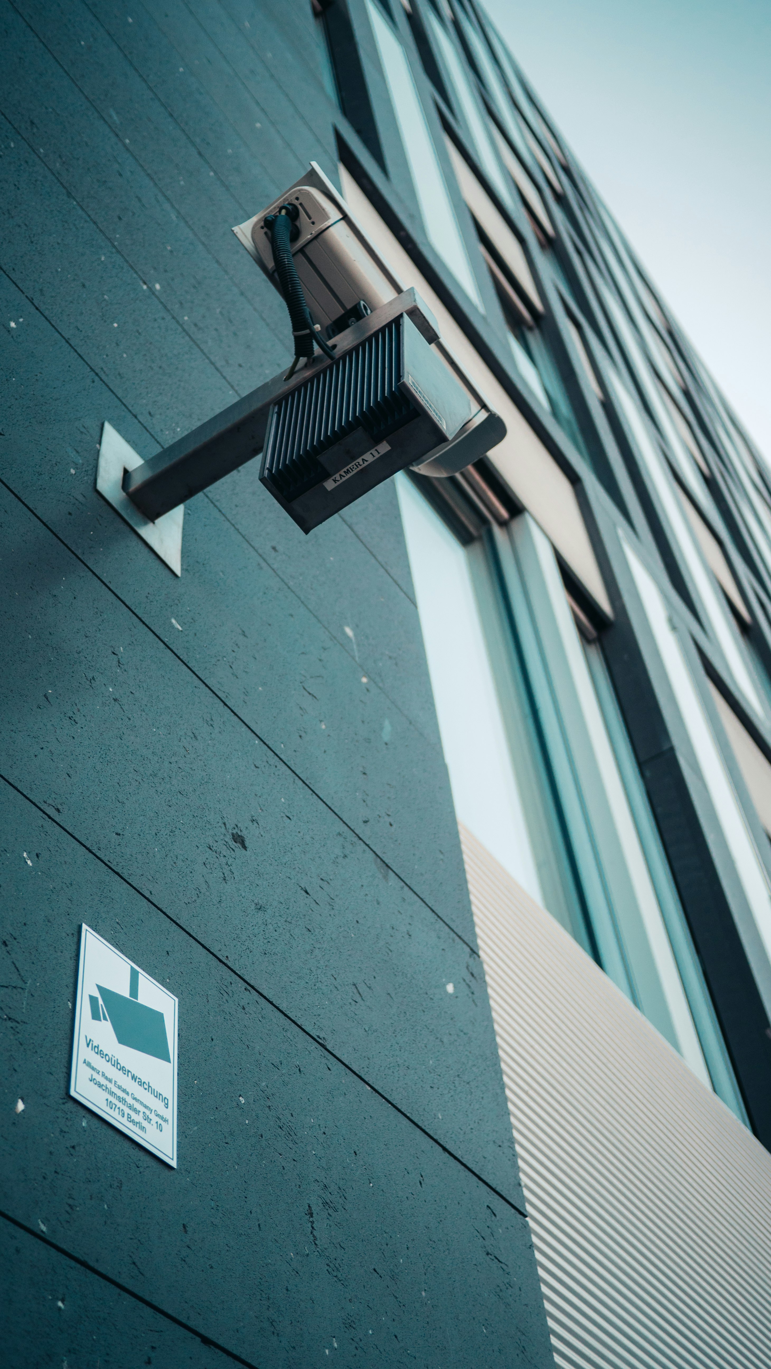 white and black building with green wall