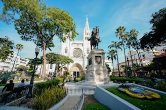 white concrete building near green trees during daytime