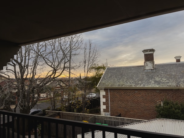 Balcony view overlooking a peaceful residential street in Rohini during sunset.