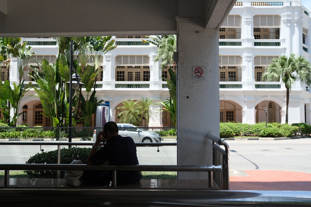 man and woman sitting on bench