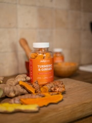 orange plastic bottle on brown wooden table