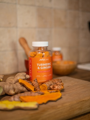 orange plastic bottle on brown wooden table
