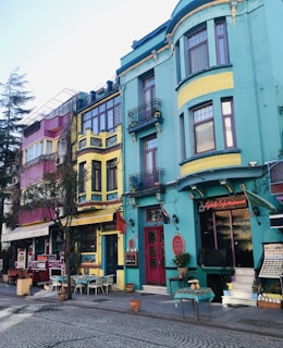 A scenic view of a vibrant Mexican street lined with colorful buildings and outdoor dining.