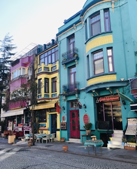 A scenic view of a vibrant Mexican street lined with colorful buildings and outdoor dining.