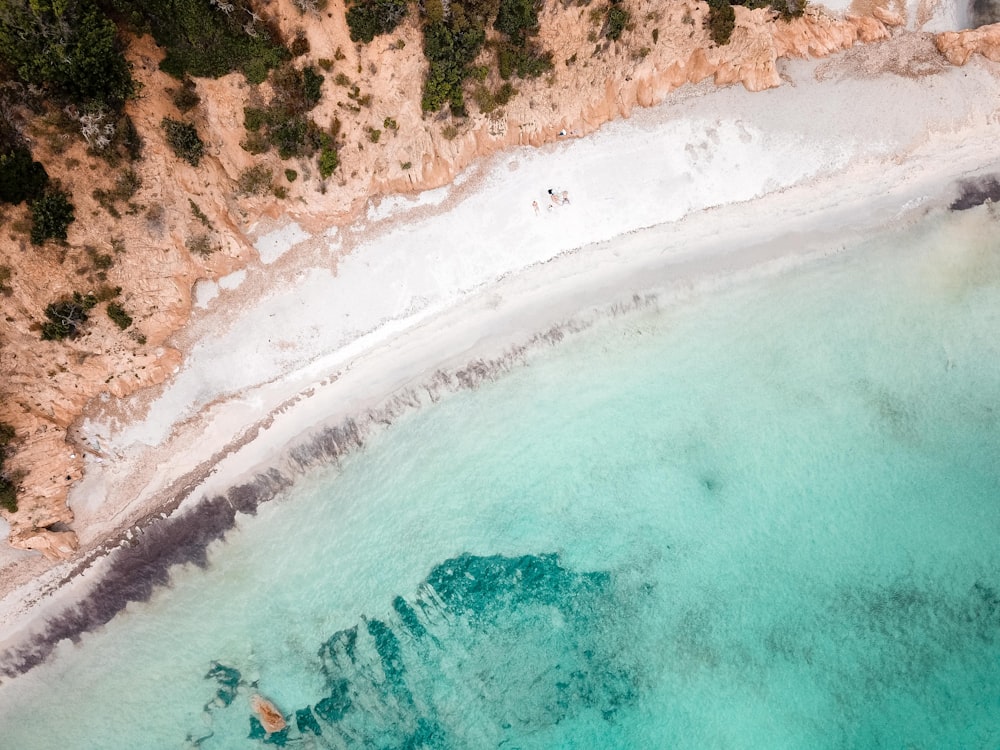 aerial view of ocean waves crashing on shore during daytime